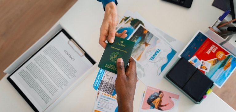 top-view-hands-holding-travel-documents (1)